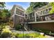 Multi-level deck and stone walkway surrounded by lush landscaping and mature trees create a tranquil backyard space at 1164 Bonview Ne Ln, Atlanta, GA 30324