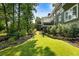 Lush green lawn and landscaped backyard with trees surrounding the house at 1164 Bonview Ne Ln, Atlanta, GA 30324