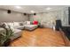 Finished basement with hardwood floors, stacked stone wall, plush couch and entertainment center at 1164 Bonview Ne Ln, Atlanta, GA 30324