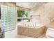 Bathroom features a large tub, glass block window, and modern finishes at 1164 Bonview Ne Ln, Atlanta, GA 30324