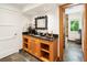 Well-lit bathroom features wood vanity, dark countertop, and decorative mirror at 1164 Bonview Ne Ln, Atlanta, GA 30324