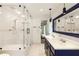 Bright bathroom featuring a glass shower, double vanity with blue cabinetry, and modern fixtures at 1164 Bonview Ne Ln, Atlanta, GA 30324
