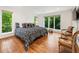 Bright bedroom with wood floors, large windows, and comfortable queen-sized bed at 1164 Bonview Ne Ln, Atlanta, GA 30324