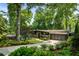 Beautiful stone home featuring mature trees, manicured lawn, circular driveway, and a two-car garage at 1164 Bonview Ne Ln, Atlanta, GA 30324