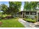 Stunning stone facade featuring manicured greenery and a walkway to a charming wooden front door at 1164 Bonview Ne Ln, Atlanta, GA 30324