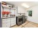 Well-organized laundry room with cabinets, shelving and modern machines at 1164 Bonview Ne Ln, Atlanta, GA 30324