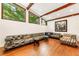 Spacious living room with hardwood floors, exposed beams, and oversized windows showcasing the backyard at 1164 Bonview Ne Ln, Atlanta, GA 30324