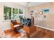Bright home office featuring hardwood floors, a unique desk, and a large window with a view at 1164 Bonview Ne Ln, Atlanta, GA 30324