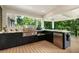 Modern outdoor kitchen featuring stainless steel appliances, marble countertops, and a stunning wooded view at 1164 Bonview Ne Ln, Atlanta, GA 30324
