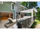 Spacious outdoor patio featuring comfortable seating, a lounge chair, and a covered deck above at 1164 Bonview Ne Ln, Atlanta, GA 30324
