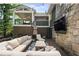 Outdoor patio featuring comfortable seating, an outdoor TV, and a second story covered patio at 1164 Bonview Ne Ln, Atlanta, GA 30324