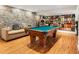 Finished basement features a pool table, jukebox, stone accent wall, and comfortable seating at 1164 Bonview Ne Ln, Atlanta, GA 30324