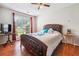 Inviting bedroom features a plush bed, bright window, and dark wood floors at 1921 Flint Hill Dr, Lawrenceville, GA 30044