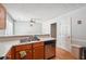 An open kitchen features stainless steel dishwasher, sink, and view to the living area at 1921 Flint Hill Dr, Lawrenceville, GA 30044