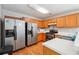 Bright kitchen with stainless steel appliances, ample counter space and wood cabinets for lots of storage at 1921 Flint Hill Dr, Lawrenceville, GA 30044