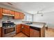 Traditional kitchen features wood cabinets, stainless steel appliances, and hardwood floors at 1921 Flint Hill Dr, Lawrenceville, GA 30044
