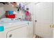 Functional laundry area featuring washer, dryer, and storage shelves for organization and convenience at 1921 Flint Hill Dr, Lawrenceville, GA 30044