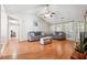 Open concept living room with vaulted ceiling, hardwood floors, ceiling fan and access to the dining room at 1921 Flint Hill Dr, Lawrenceville, GA 30044