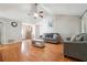 Open concept living room with vaulted ceiling, hardwood floors, ceiling fan and access to the foyer at 1921 Flint Hill Dr, Lawrenceville, GA 30044