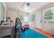 Cozy sunroom with wood floors, many windows, and blue rug, perfect for relaxing or entertaining guests at 1921 Flint Hill Dr, Lawrenceville, GA 30044