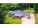 Aerial view of the property displaying the well-maintained landscaping, large driveway, and home's layout at 241 Sarann Nw Ct, Lilburn, GA 30047