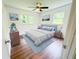Cozy bedroom with a comfortable bed, soft blue rug, and natural light from the windows at 241 Sarann Nw Ct, Lilburn, GA 30047
