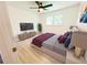 Stylish bedroom featuring a comfortable bed, ceiling fan, and ample natural light from the window at 241 Sarann Nw Ct, Lilburn, GA 30047