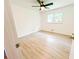 Clean and bright bedroom with light wood floors, ceiling fan and a window with a view at 241 Sarann Nw Ct, Lilburn, GA 30047