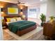 Stylish bedroom featuring a wood accent wall, modern furniture, and ample natural light at 241 Sarann Nw Ct, Lilburn, GA 30047