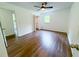 An empty bedroom featuring hardwood floors, a ceiling fan, and a closet at 241 Sarann Nw Ct, Lilburn, GA 30047