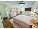 Bright bedroom with a neutral color palette, ceiling fan, and plush rug at 241 Sarann Nw Ct, Lilburn, GA 30047