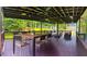 Inviting covered deck with ceiling fan, dining set, and comfortable outdoor seating overlooking the backyard at 241 Sarann Nw Ct, Lilburn, GA 30047