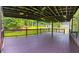 Spacious covered deck with stained flooring and ceiling, offering ample space for entertaining and relaxation at 241 Sarann Nw Ct, Lilburn, GA 30047