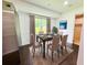 Dining room with a table set for six, hardwood floors, and a large window with natural light at 241 Sarann Nw Ct, Lilburn, GA 30047