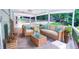 Inviting porch with wicker furniture, including a sofa, chairs, and a coffee table, for outdoor relaxation at 241 Sarann Nw Ct, Lilburn, GA 30047