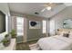 This stylish bedroom features neutral walls, carpet, a ceiling fan, and a mounted TV at 256 Turnstone Rd, Stockbridge, GA 30281