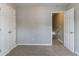 This bedroom has neutral walls, carpet, two closets, and an open door at 256 Turnstone Rd, Stockbridge, GA 30281