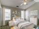 This stylish bedroom features neutral walls, carpet, a ceiling fan, and natural light at 256 Turnstone Rd, Stockbridge, GA 30281