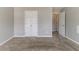 This is a bedroom with neutral walls, carpet, and white closet doors at 256 Turnstone Rd, Stockbridge, GA 30281