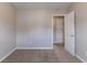 This bedroom has neutral walls, carpet, and an open door at 256 Turnstone Rd, Stockbridge, GA 30281