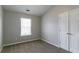 This bedroom features neutral walls, carpet, a window, and a closet at 256 Turnstone Rd, Stockbridge, GA 30281