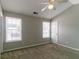 This bedroom features neutral walls, carpet, a ceiling fan, and natural light at 256 Turnstone Rd, Stockbridge, GA 30281