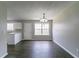 Bright dining area with modern light fixture and wood-look floors at 256 Turnstone Rd, Stockbridge, GA 30281