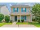Charming two-story home featuring vinyl siding, bright blue shutters, and a well-maintained front yard at 256 Turnstone Rd, Stockbridge, GA 30281