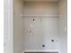 A simple laundry area with a rack and connections at 256 Turnstone Rd, Stockbridge, GA 30281