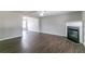 Open floor plan with living room fireplace, dark wood floors, and natural light at 256 Turnstone Rd, Stockbridge, GA 30281