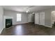 Spacious living room with a cozy fireplace, dark wood flooring, and plenty of natural light at 256 Turnstone Rd, Stockbridge, GA 30281