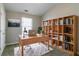 This office has neutral walls, a bookshelf, carpet, a rug, a window, and a desk with a laptop at 256 Turnstone Rd, Stockbridge, GA 30281