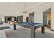 Bright game room with a blue felt pool table, modern lighting, and access to the theater room at 400 W Peachtree Nw St # 3114, Atlanta, GA 30308