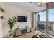 Bright living room with balcony, city views, stylish decor, and hardwood floors at 400 W Peachtree Nw St # 3114, Atlanta, GA 30308